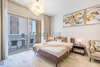 a bedroom with a bed and a large window at Contemporary Studio in Manara 6, Jebel Ali by Deluxe Holiday Homes in Dubai