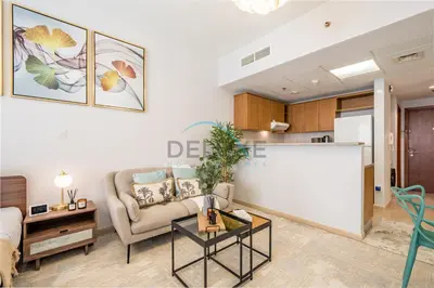 a living room with a couch and a table at Contemporary Studio in Manara 6, Jebel Ali by Deluxe Holiday Homes in Dubai