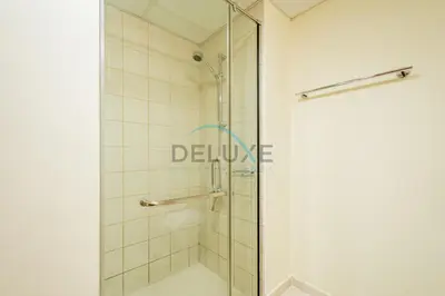 a shower with a glass door in a bathroom at Contemporary Studio in Manara 6, Jebel Ali by Deluxe Holiday Homes in Dubai