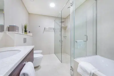 a bathroom with a shower and a toilet and a sink at GLOBALSTAY Palm View in Dubai