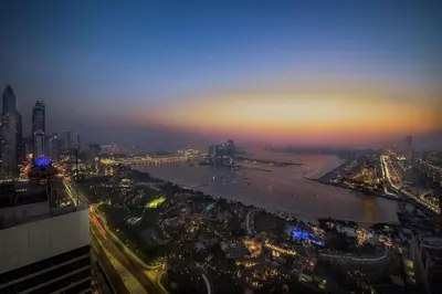 an aerial view of a city at night at GLOBALSTAY Palm View in Dubai