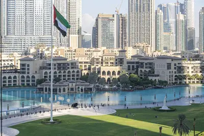 a view of a city with a river and buildings at Grande Signature by Emaar! Best Full Burj Khalifa, Fountains, Park View! in Dubai