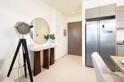 a mirror on a tripod in a living room with a camera at Grande Signature by Emaar! Best Full Burj Khalifa, Fountains, Park View! in Dubai