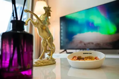 a bowl of food on a table next to a vase at Luxury Haven 2BR I Damac Vera I City Views in Dubai