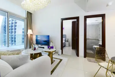 a living room with a couch and a table at Luxury Haven 2BR I Damac Vera I City Views in Dubai