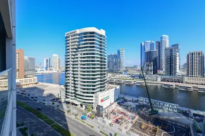 a view of a city with a river and buildings at Luxury Haven 2BR I Damac Vera I City Views in Dubai