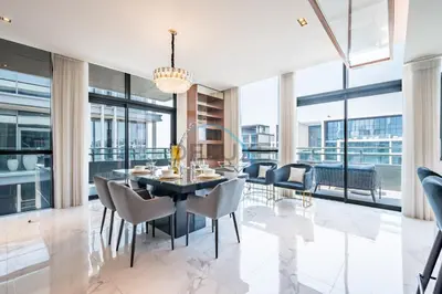 a dining room with a table and chairs at Radiant 2BR with Assistant Room at Citywalk Residential Building 7, Al Wasl by Deluxe Holiday Homes in Dubai