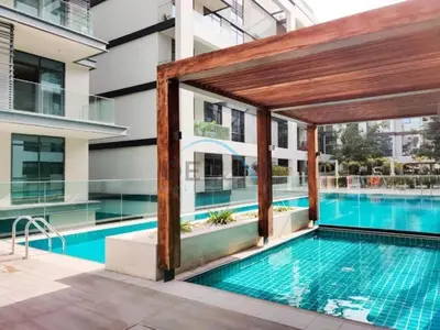 an image of a swimming pool in a building at Radiant 2BR with Assistant Room at Citywalk Residential Building 7, Al Wasl by Deluxe Holiday Homes in Dubai