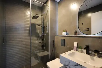 a bathroom with a toilet and a sink and a mirror at Modern Studio in JVC, Near Parks and Highways in Dubai