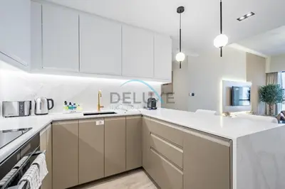 a kitchen with white cabinets and white counter tops at Luxurious 2BR Apartment at Sadaf 6, Jumeirah Beach Residence by Deluxe Holiday Homes in Dubai