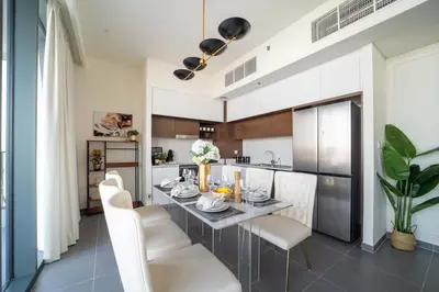 a kitchen and dining room with a table and chairs at Frank Porter - Creek Edge Tower 1 in Dubai