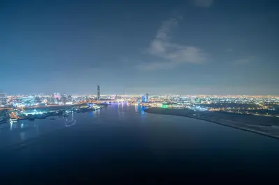 a view of a river with a city at night at Frank Porter - Creek Edge Tower 1 in Dubai