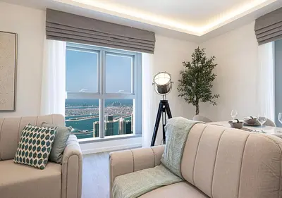 a living room with a couch and a large window at Princess Tower - Spectacular Sky Views, Palm Jumeirah & JBR Beach in Dubai