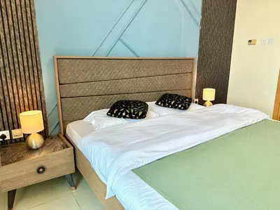 a bed with two black pillows on top of it at Renovu Exclusive Residences in Dubai in Dubai