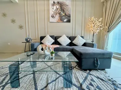 a living room with a couch and a glass table at Renovu Exclusive Residences in Dubai in Dubai