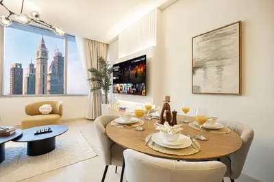 a dining room with a table and chairs and a large window at LUXE | 1BR | Heart of DIFC & Trade Centre in Dubai