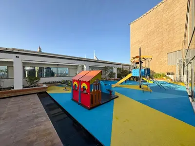 a playground with a slide and a play structure at LUXE | 1BR | Heart of DIFC & Trade Centre in Dubai