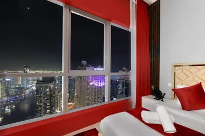 a bedroom with a window with a view of the city at Dubai Marina 3BR Penthouse with Stunning JBR, Marina & Dubai Eye Views in Dubai