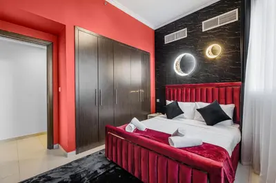 a red bedroom with a bed with a red wall at Dubai Marina 3BR Penthouse with Stunning JBR, Marina & Dubai Eye Views in Dubai