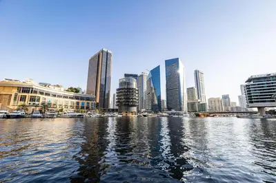 a view of a city from a river with buildings at Dubai Marina 3BR Penthouse with Stunning JBR, Marina & Dubai Eye Views in Dubai