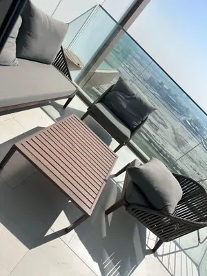 a balcony with two chairs and a table and pillows at Infinity luxury in Dubai