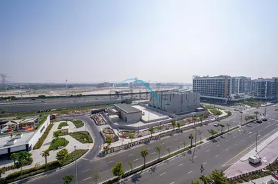an aerial view of a city with a highway at Cozy Studio in Azizi Riviera 44, Al Merkadh by Deluxe Holiday Homes in Dubai