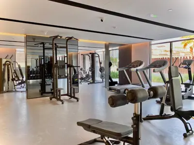 a gym with a lot of exercise equipment in a room at Trendy Studio with top Amenities in Dubai