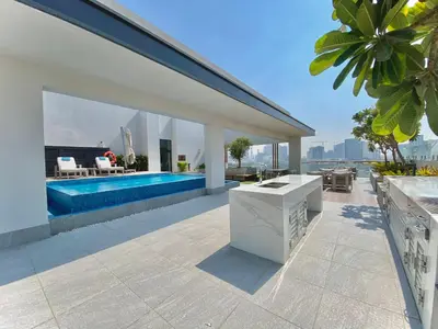 a house with a swimming pool and a patio at Trendy Studio with top Amenities in Dubai