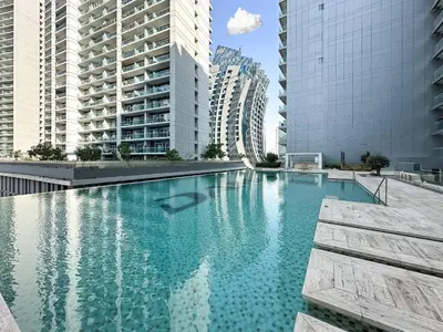 a swimming pool in a city with tall buildings at Trophy Stays - Supreme Opulence - Chic Studio in Business Bay in Dubai