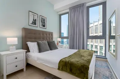 a bedroom with a large bed with a large window at Burj Khalifa Views - 5 min walk from Dubai Mall - Upgraded - Designer Choice - 8 people - Dubai Opera in Dubai
