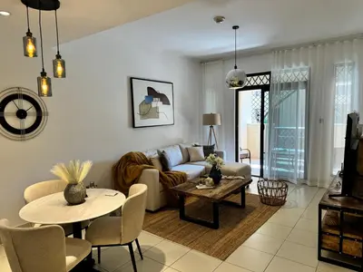 a living room with a couch and a table at Luxurious 1BR Aprt Burj Khalifa Area in Dubai