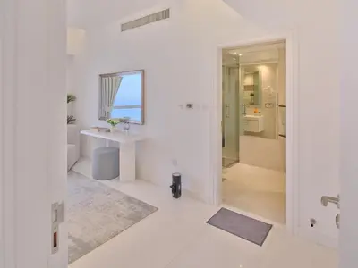 a white bathroom with a sink and a mirror at JBR Beachfront Luxe apartment all Rooms Sea Facing in Dubai