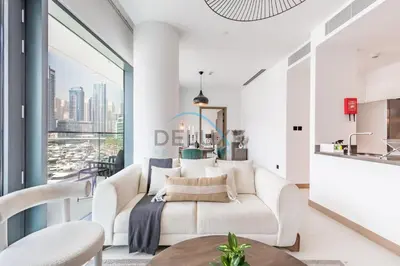 a living room with a white couch and a large window at Modern 2BR in VIDA Residences Dubai Marina by Deluxe Holiday Homes in Dubai