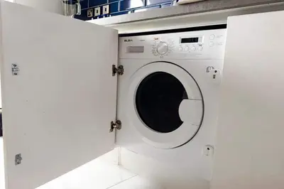 a white washing machine in a laundry room at kinda Holiday Homes- Mag 318 Downtown in Dubai