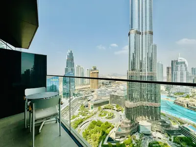 a balcony with a view of a city at Skyline Retreat 3 Bedroom at Address Opera I Burj Khalifa & Fountain Views in Dubai