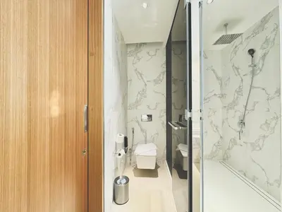 a bathroom with a toilet and a shower at Skyline Retreat 3 Bedroom at Address Opera I Burj Khalifa & Fountain Views in Dubai