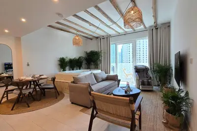 a living room with a couch and a table at Private Spa 1BR Biophilic Retreat With Beach Access & Infinity Pool in Dubai