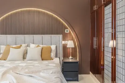 a bedroom with a large bed with a wooden headboard at Elegant 3BR Lux Stay in the Heart of Dubai Marina in Dubai