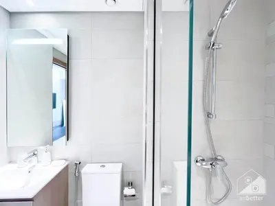 a bathroom with a shower and a toilet and a sink at Breath taking Studio with Balcony & Stunning Views in Dubai