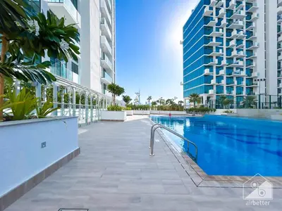 a swimming pool in a building with tall buildings at Breath taking Studio with Balcony & Stunning Views in Dubai
