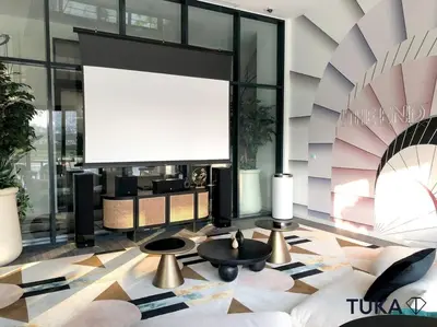 a living room with a large screen in a building at Stunning 2-BHK Golfville at Dubai Hills Prime in Dubai