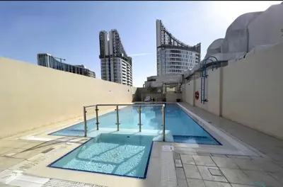 a swimming pool on the roof of a building at 1BR in Mayfair tower Business bay! Burj views, close to Dubai mall in Dubai