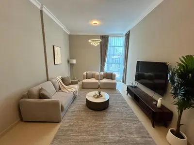 a living room with a couch and a table at 1BR in Mayfair tower Business bay! Burj views, close to Dubai mall in Dubai