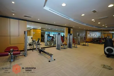 a gym with treadmills and cardio equipment in a building at Alashrafia Saray- Peaceful studio in Canal Views in Dubai