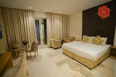 a hotel room with a bed and a living room at Alashrafia Saray- Peaceful studio in Canal Views in Dubai