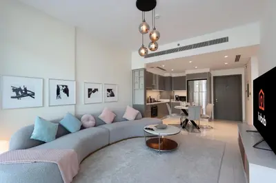 a living room with a couch and a table at 2BR Beachfront Living, Stunning Marina Views in Dubai
