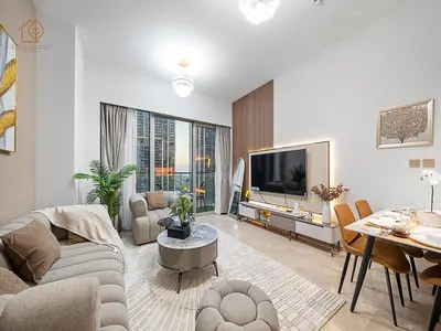 a living room with a couch and a tv and a table at Luxury Home with City Views Near Dubai Mall 196GR-1 in Dubai
