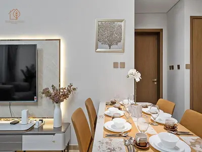 a dining room with a table with chairs and a television at Luxury Home with City Views Near Dubai Mall 196GR-1 in Dubai