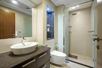 a bathroom with a sink and a toilet and a shower at DAYF-ALI City's Heart Chic 1 BR Huge Terrace and Great Access in Dubai