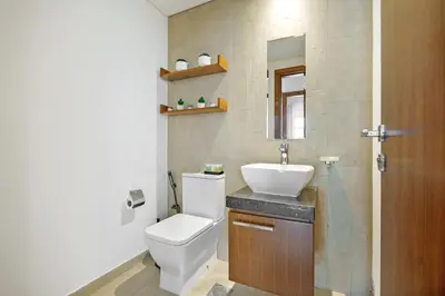 a bathroom with a white toilet and a sink at DAYF-ALI City's Heart Chic 1 BR Huge Terrace and Great Access in Dubai